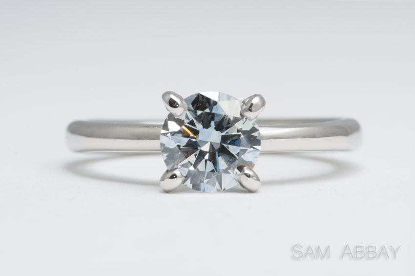 light solitaire with blue diamond